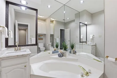a bathroom with a double vanity sink mirror and double