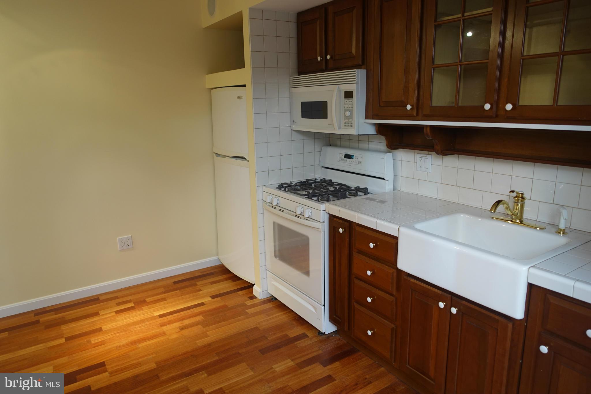 1526 12th Street Northwest, Unit 2 Washington, DC 20005 - Photo 5 of 15 a kitchen with a stove and a refrigerator