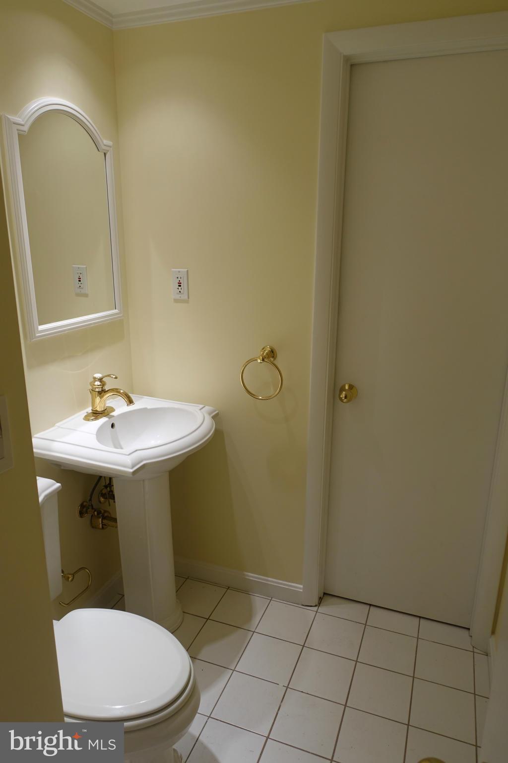 1526 12th Street Northwest, Unit 2 Washington, DC 20005 - Photo 6 of 15 a bathroom with a sink a toilet and mirror