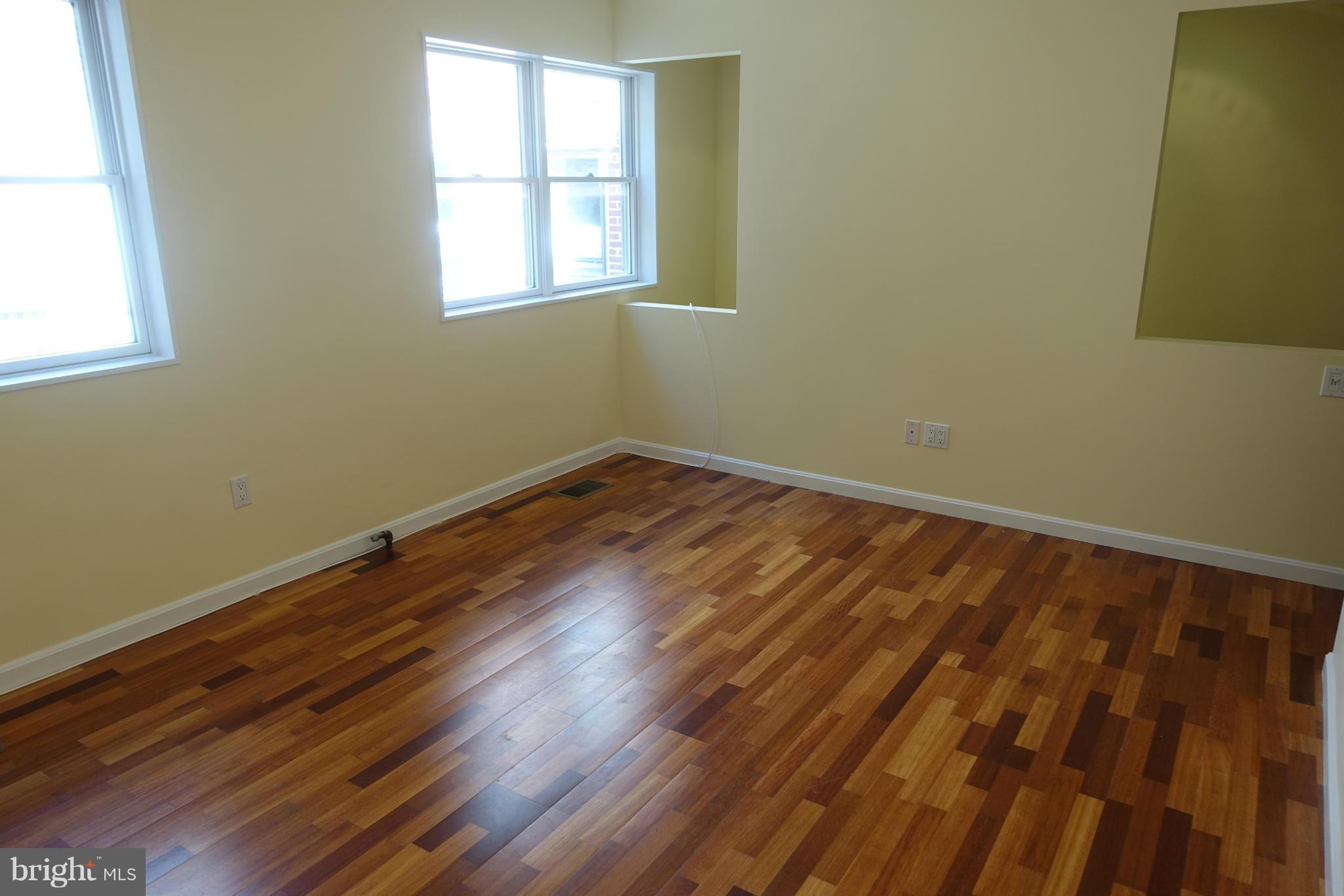 1526 12th Street Northwest, Unit 2 Washington, DC 20005 - Photo 9 of 15 an empty room with wooden floor and windows