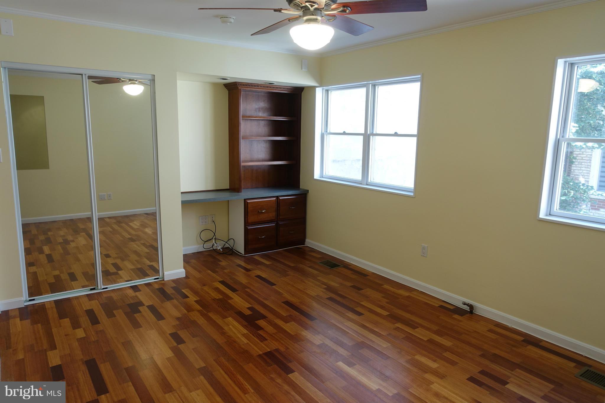 1526 12th Street Northwest, Unit 2 Washington, DC 20005 - Photo 10 of 15 a view of an empty room with window and wooden floor