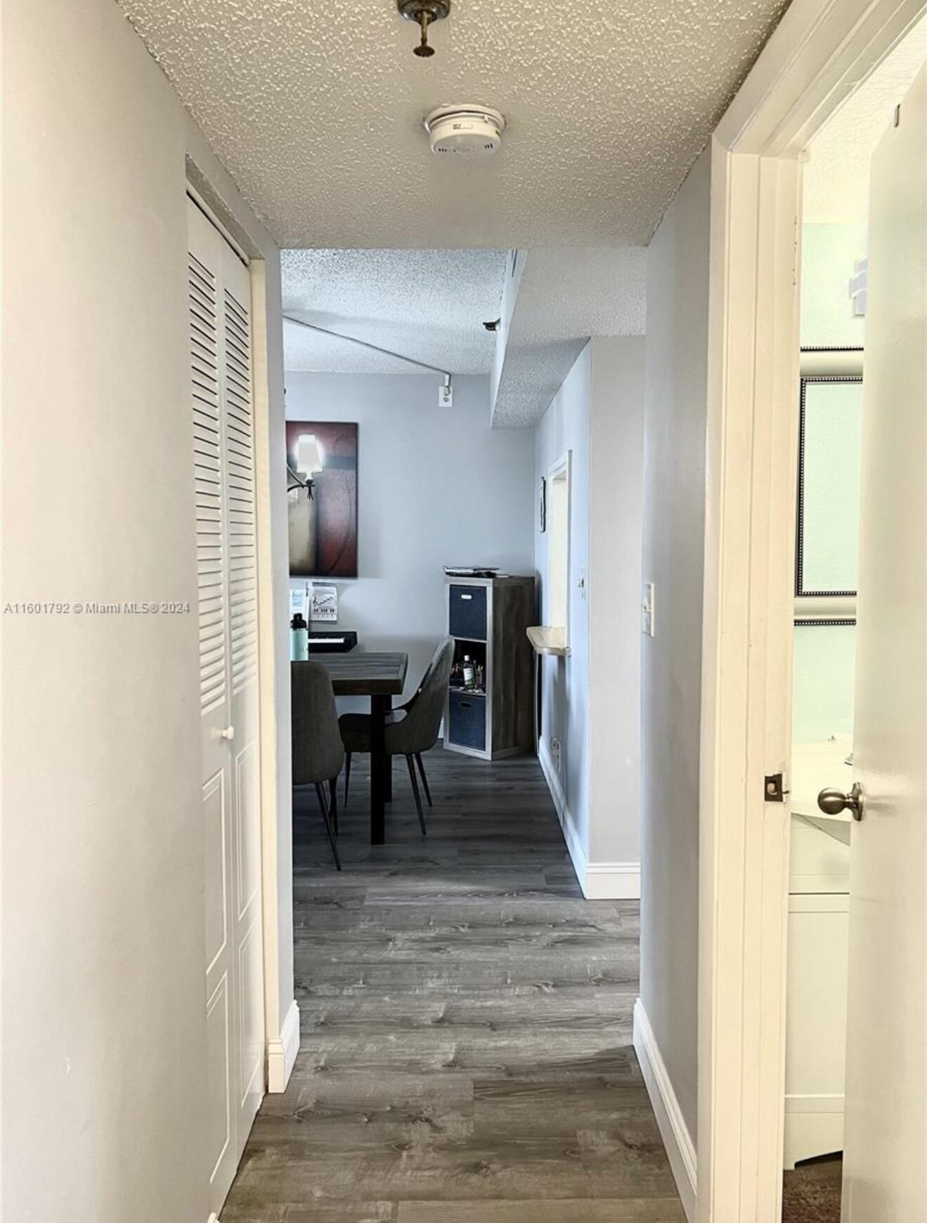 9235 Southwest 8th Street, Unit 507 Boca Raton, FL 33428 - Photo 12 of 16 a view of a hallway with furniture and a window