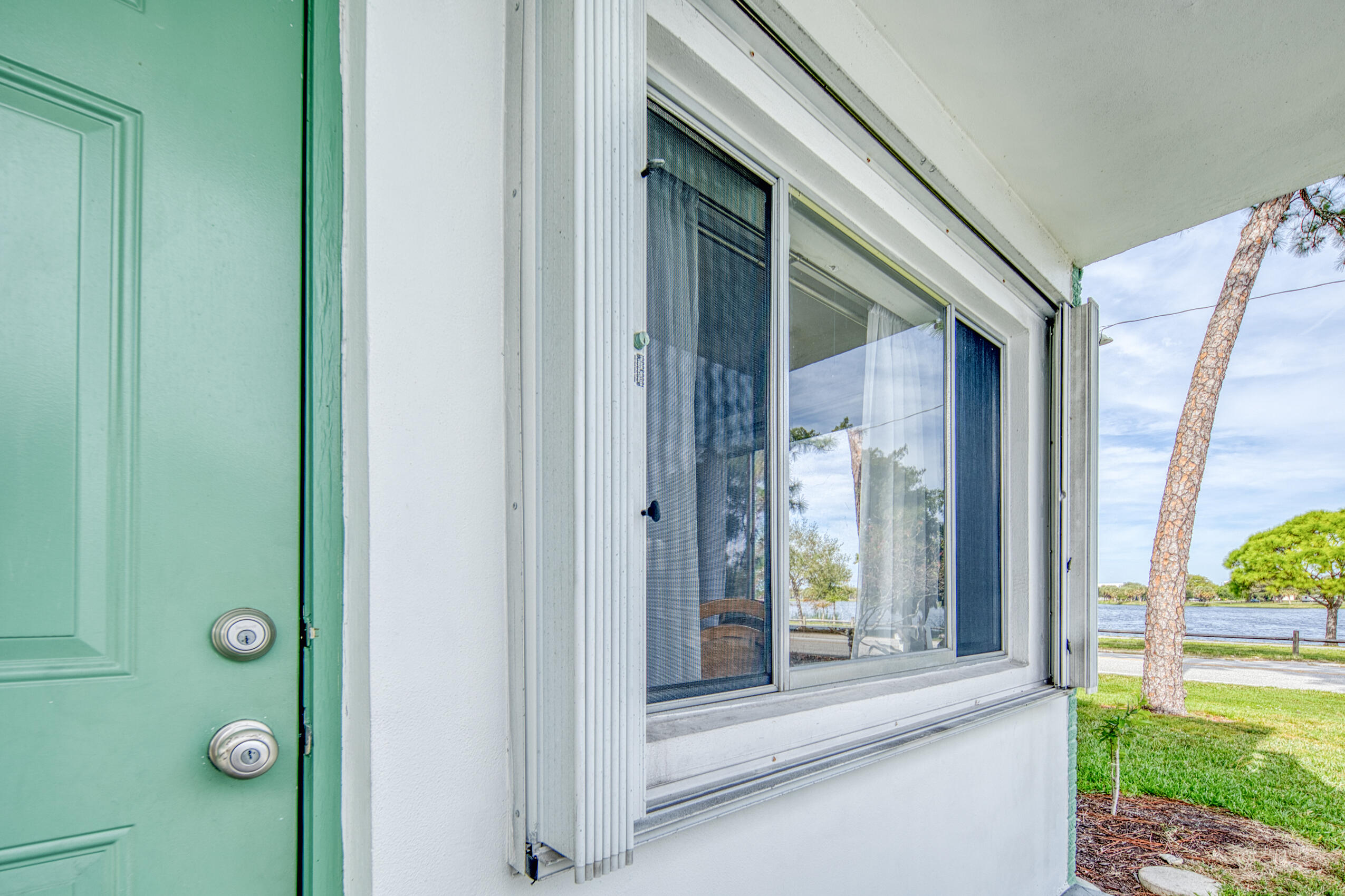 2004 Lake Osborne Drive, Unit 1 Lake Worth Beach, FL 33461 - Photo 13 of 30 a view of a door and chair in front of a door