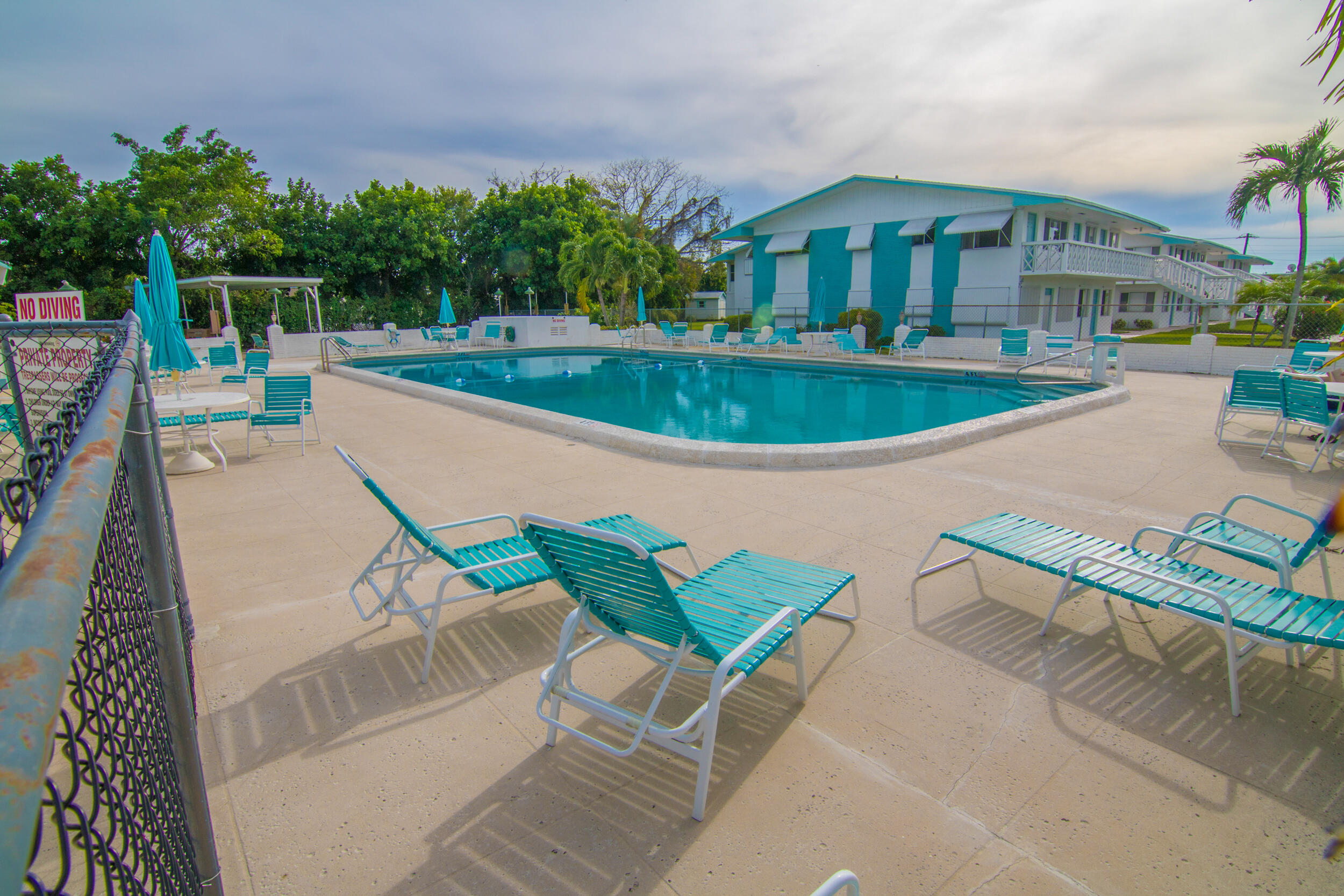 2004 Lake Osborne Drive, Unit 1 Lake Worth Beach, FL 33461 - Photo 26 of 30 a view of a swimming pool with a patio