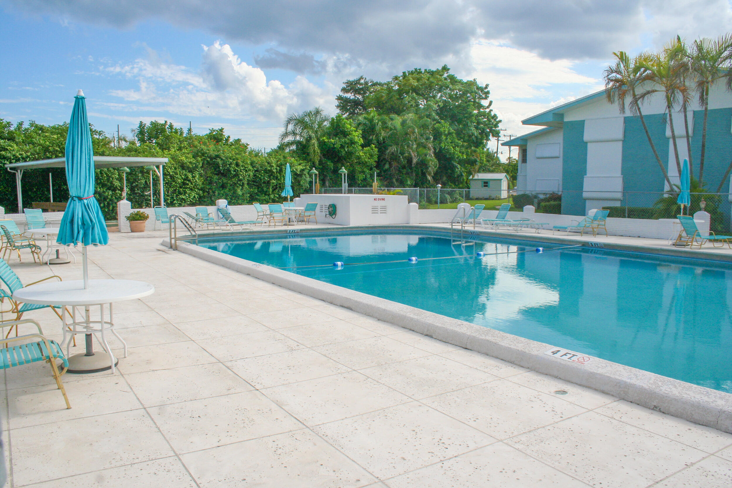 2004 Lake Osborne Drive, Unit 1 Lake Worth Beach, FL 33461 - Photo 27 of 30 a view of a swimming pool with a lounge chair