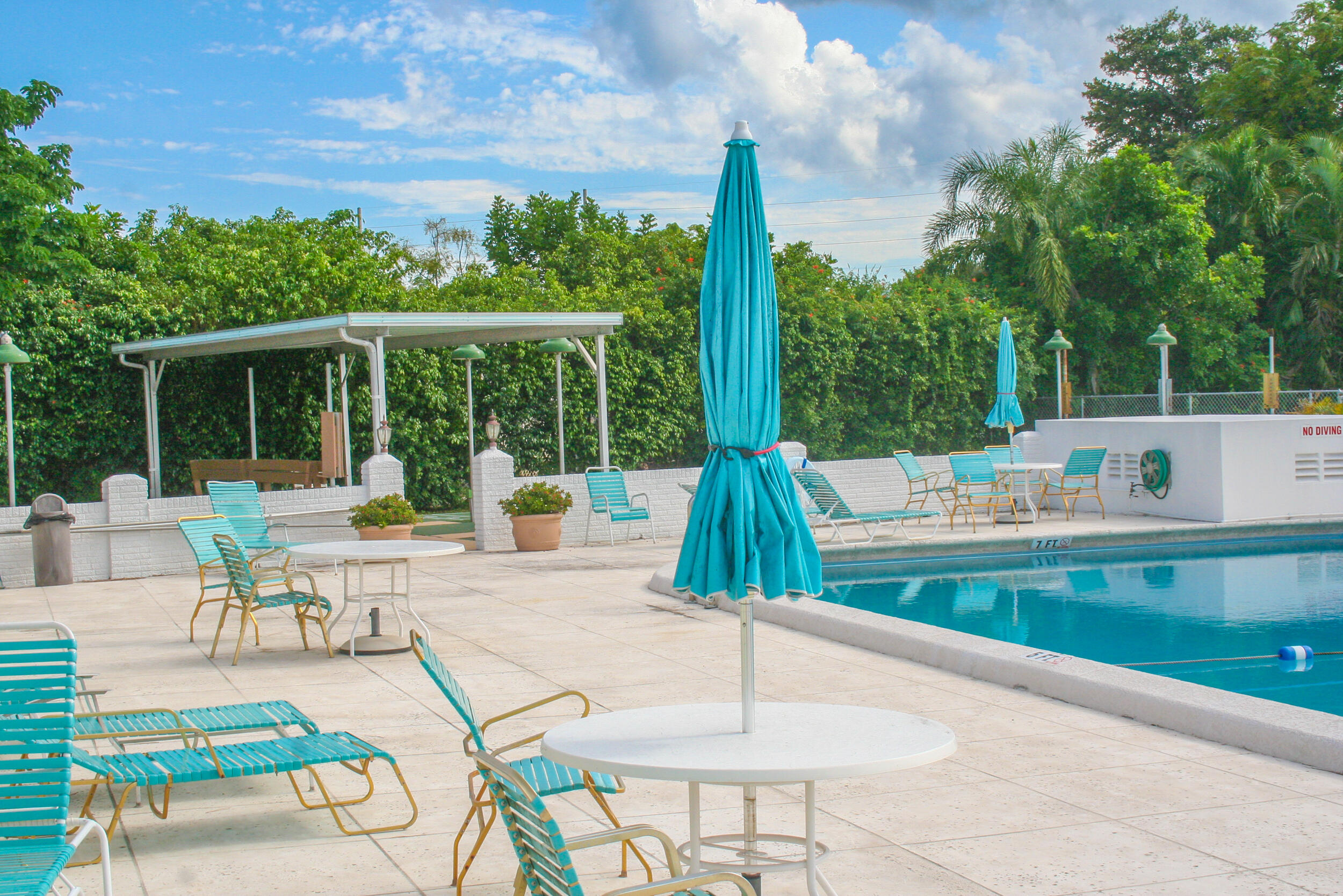 2004 Lake Osborne Drive, Unit 1 Lake Worth Beach, FL 33461 - Photo 28 of 30 a view of a patio with a table chairs and a table
