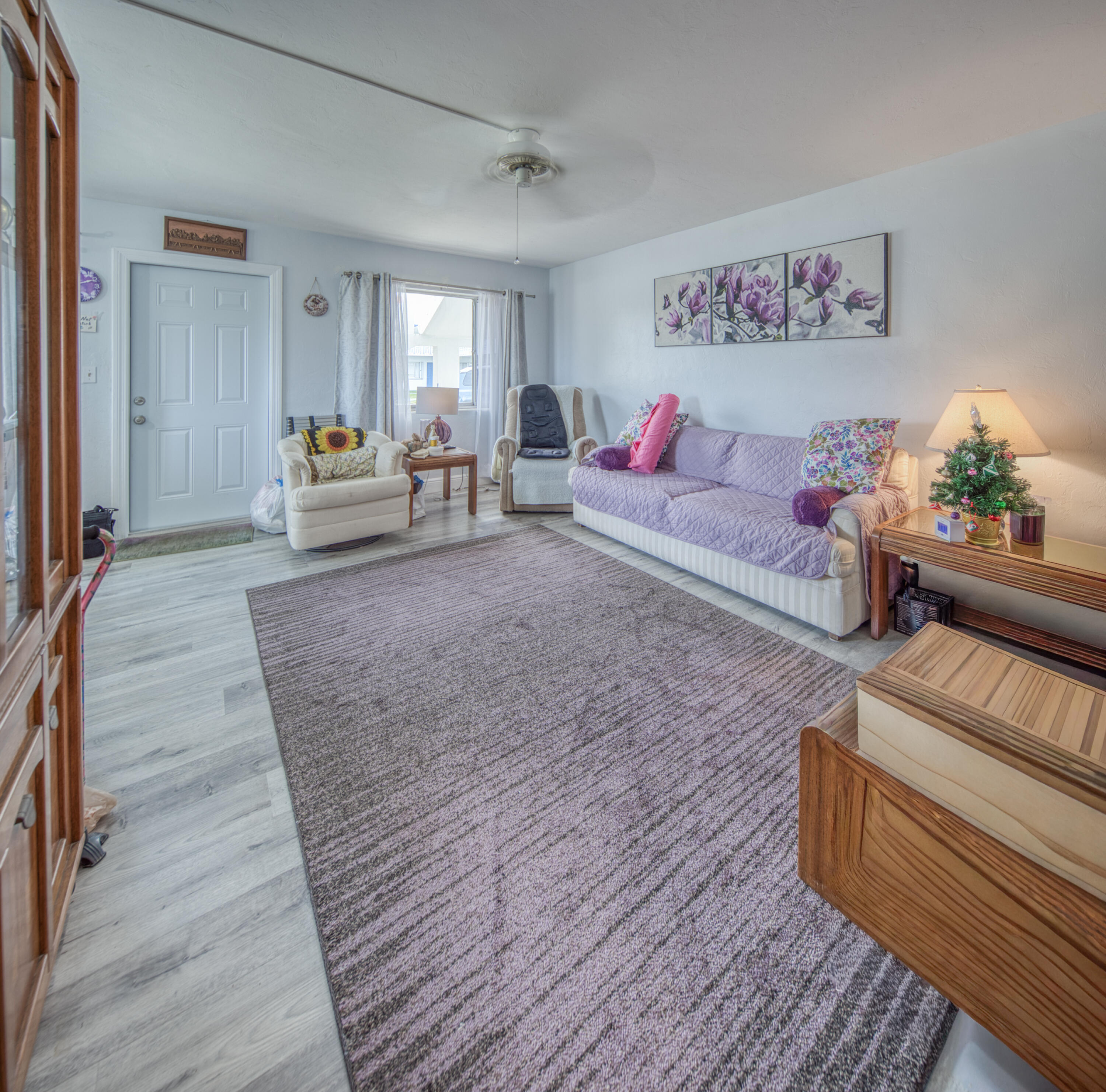 2004 Lake Osborne Drive, Unit 1 Lake Worth Beach, FL 33461 - Photo 3 of 30 a spacious bedroom with a bed and a couch