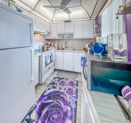 a kitchen with stainless steel appliances granite countertop a sink and cabinets
