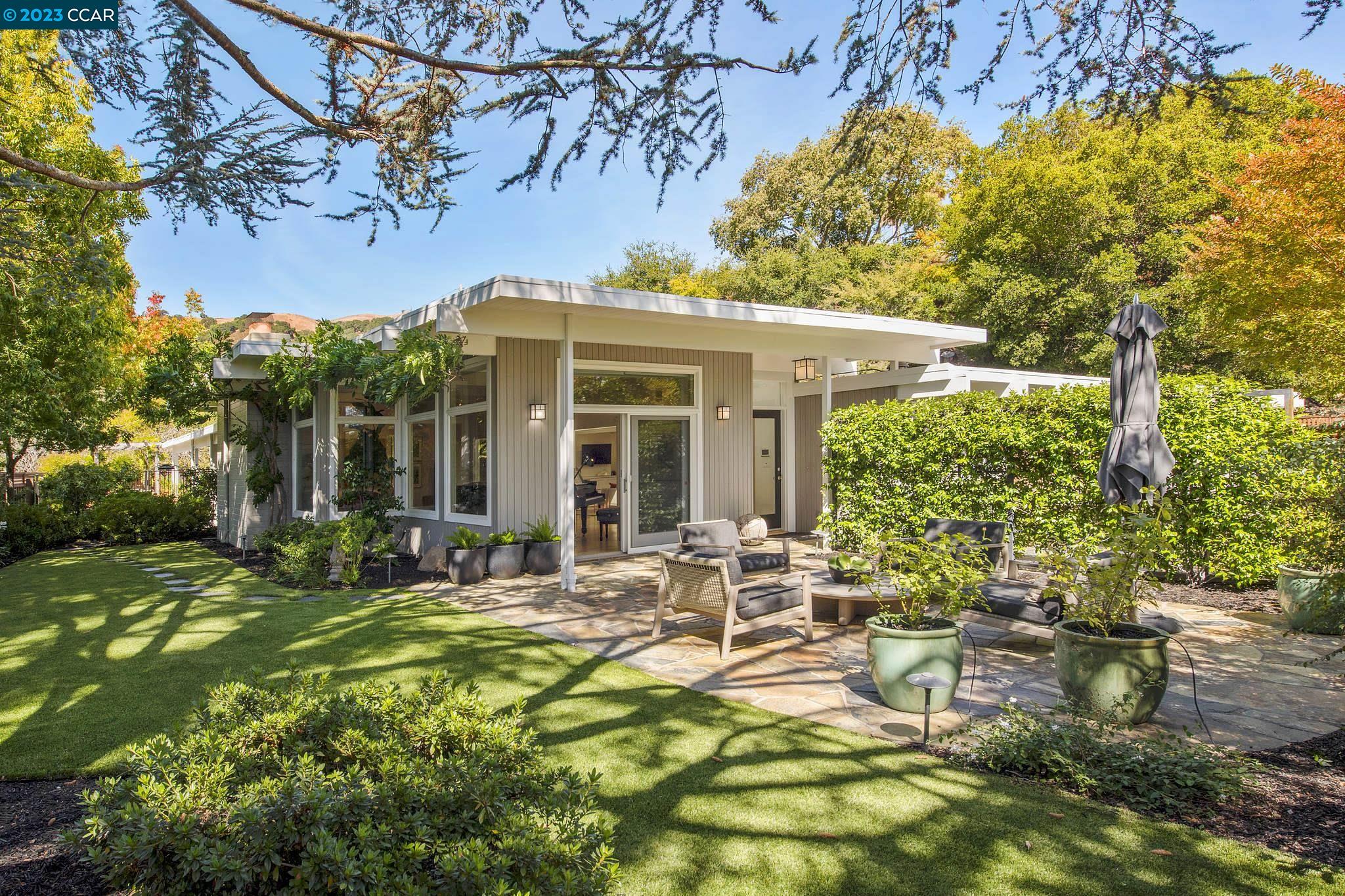 a view of a house with backyard porch and sitting area