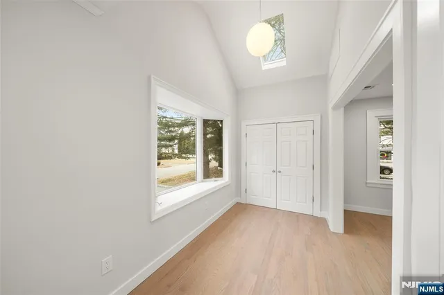 an empty room with windows and closet