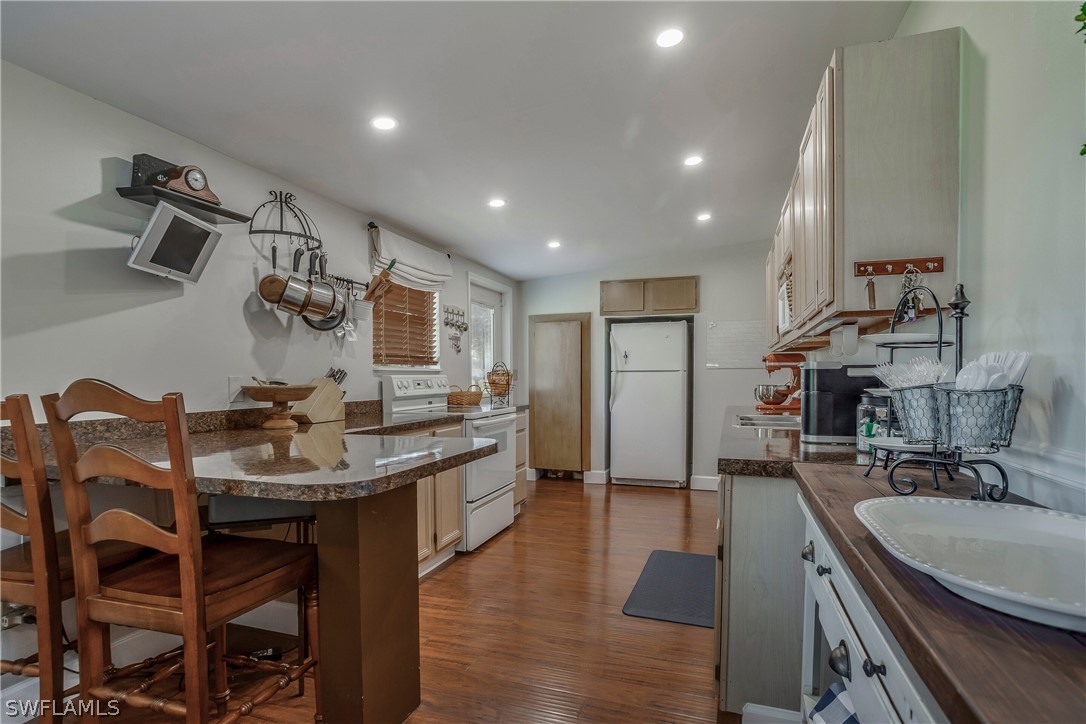 23751 North River Road Alva, FL 33920 - Photo 11 of 34 a kitchen with kitchen island granite countertop lots of counter top space and stainless steel appliances