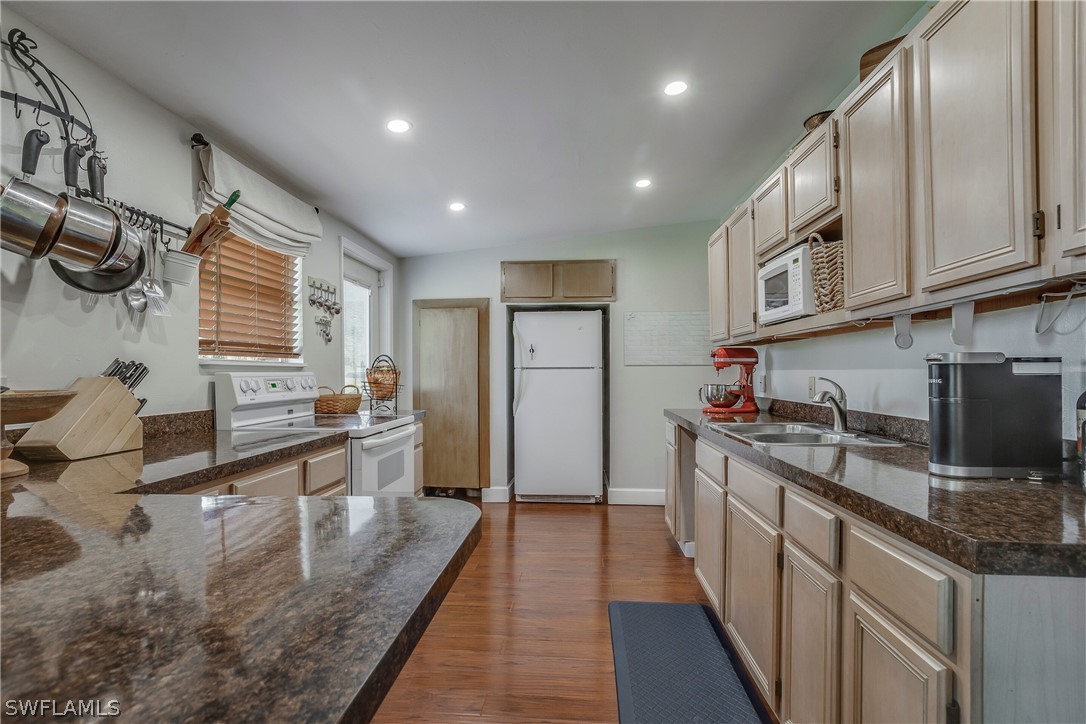 23751 North River Road Alva, FL 33920 - Photo 12 of 34 a kitchen with stainless steel appliances granite countertop sink stove refrigerator and cabinets