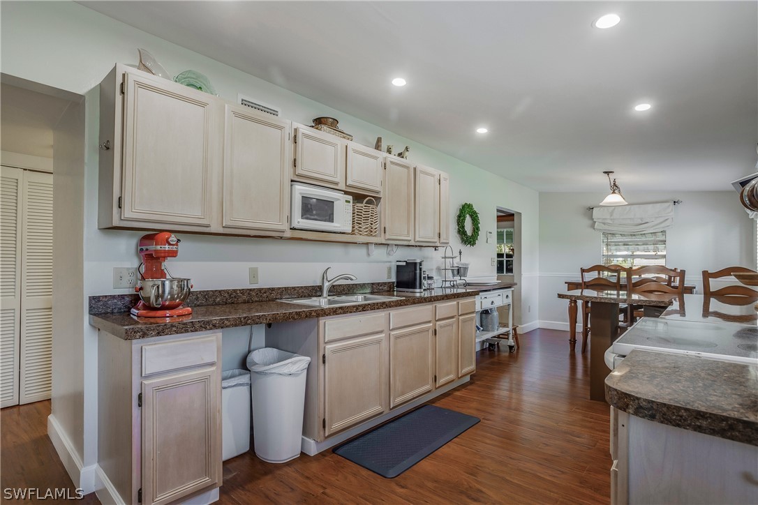 23751 North River Road Alva, FL 33920 - Photo 14 of 34 a kitchen with stainless steel appliances granite countertop a sink stove and refrigerator