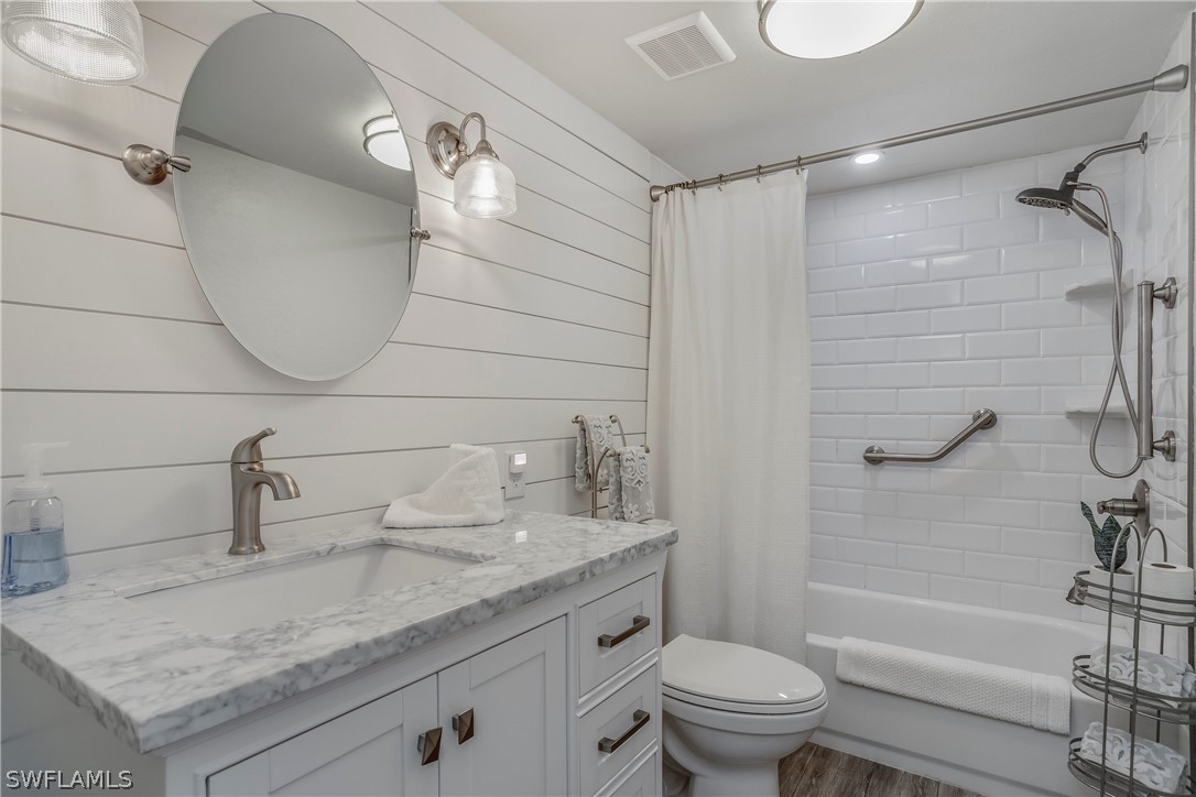 23751 North River Road Alva, FL 33920 - Photo 16 of 34 a bathroom with a granite countertop sink a toilet and shower