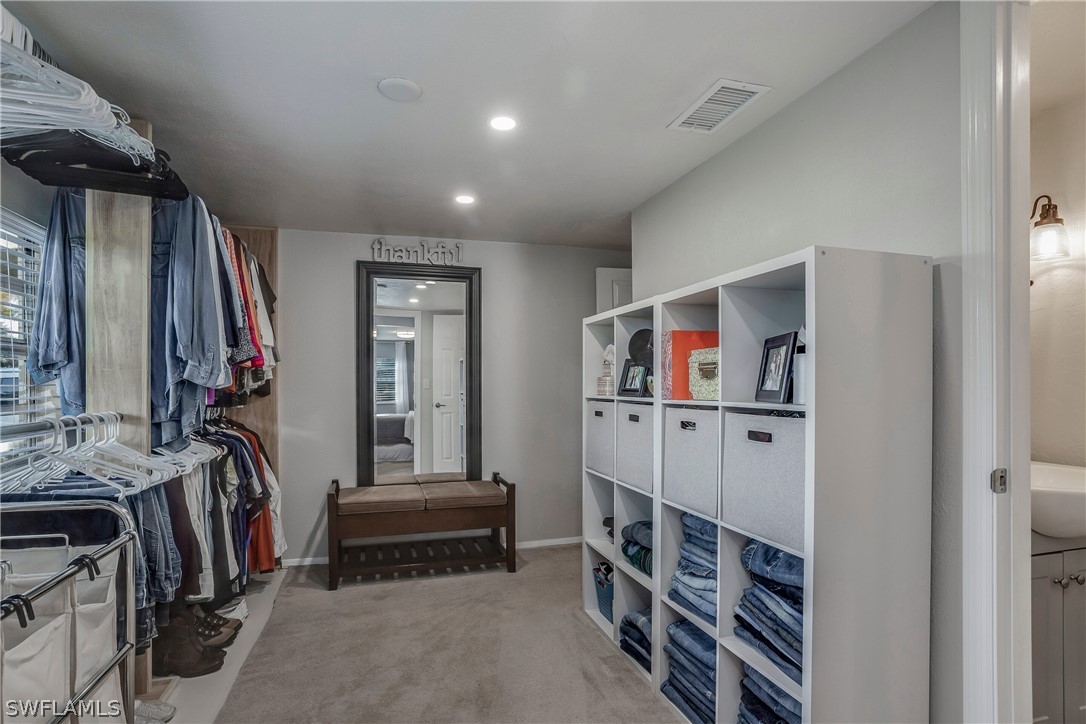 23751 North River Road Alva, FL 33920 - Photo 18 of 34 a view of walk in closet with clothes and shoes