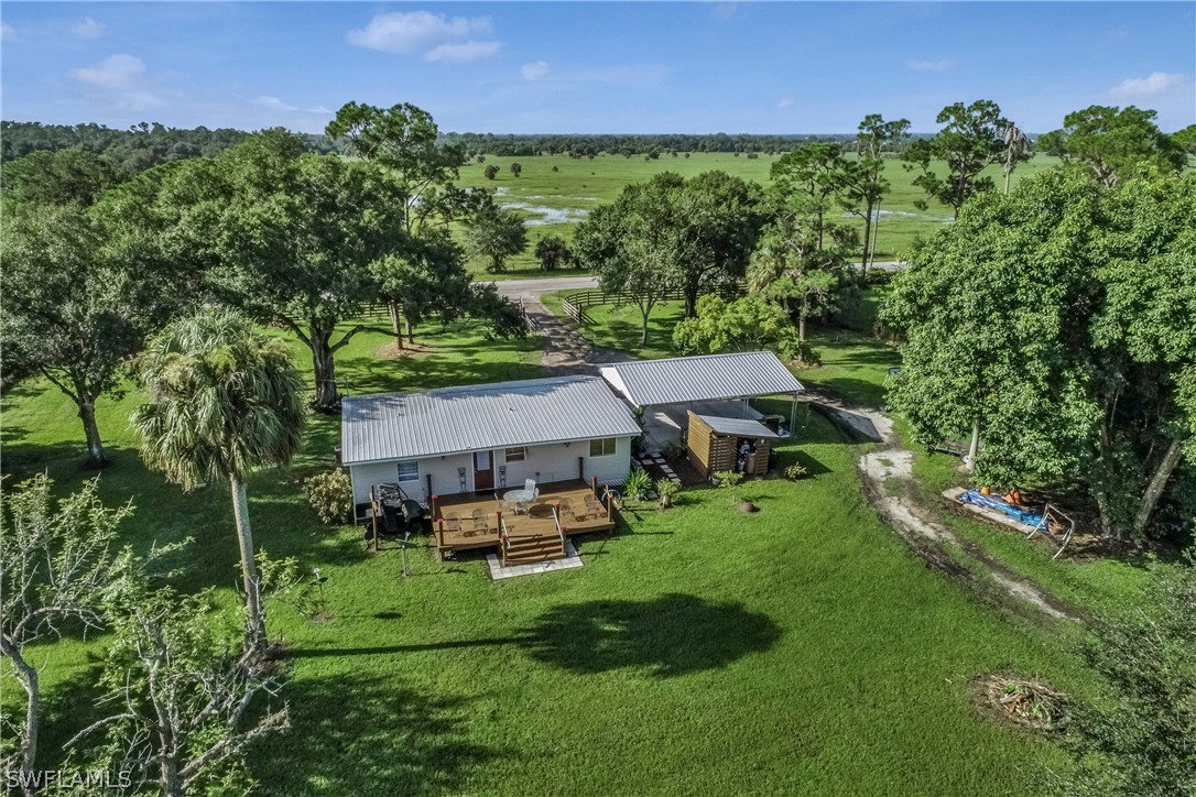 23751 North River Road Alva, FL 33920 - Photo 23 of 34 an aerial view of residential houses with outdoor space and trees all around