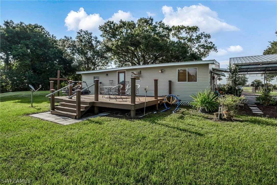 23751 North River Road Alva, FL 33920 - Photo 25 of 34 a view of a house with backyard sitting area and garden