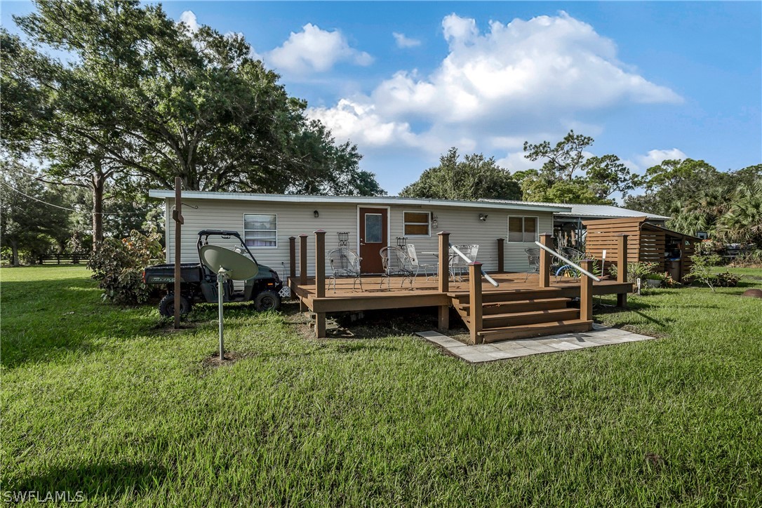 23751 North River Road Alva, FL 33920 - Photo 26 of 34 a view of a house with backyard porch and sitting area