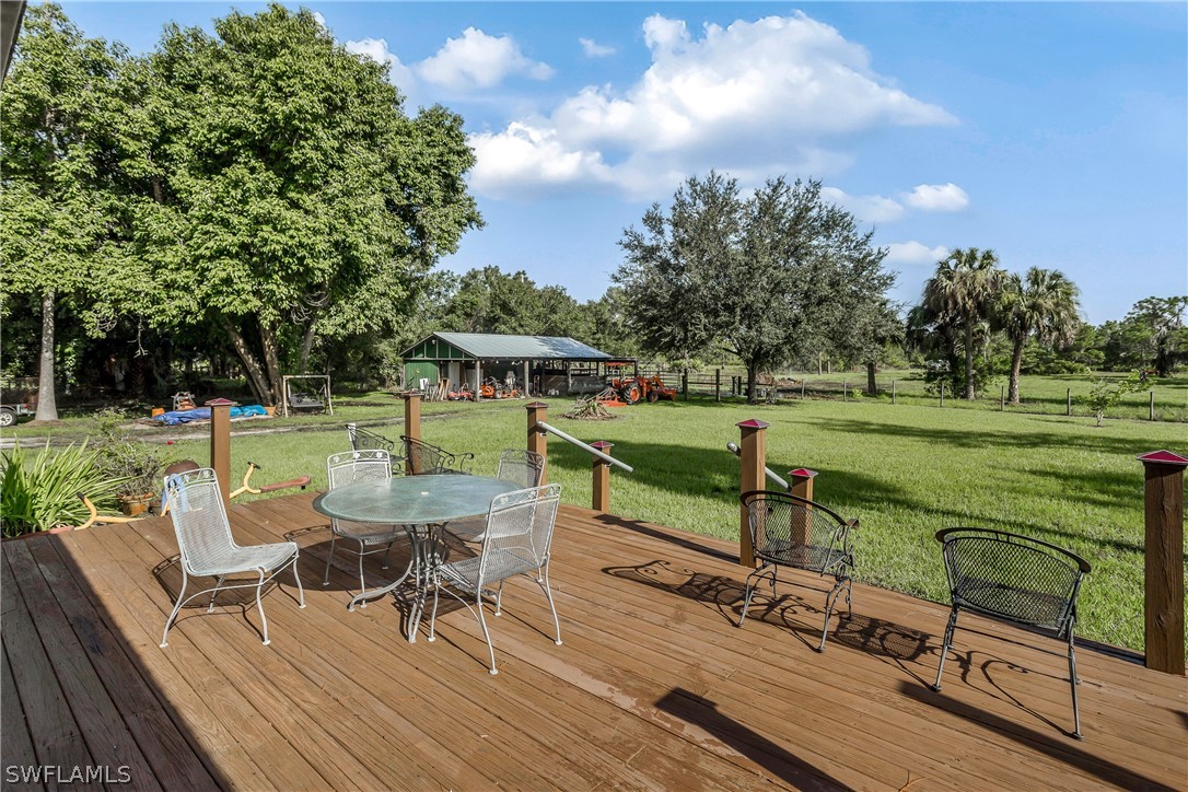 23751 North River Road Alva, FL 33920 - Photo 27 of 34 a view of a chairs and tables in the back yard of the house