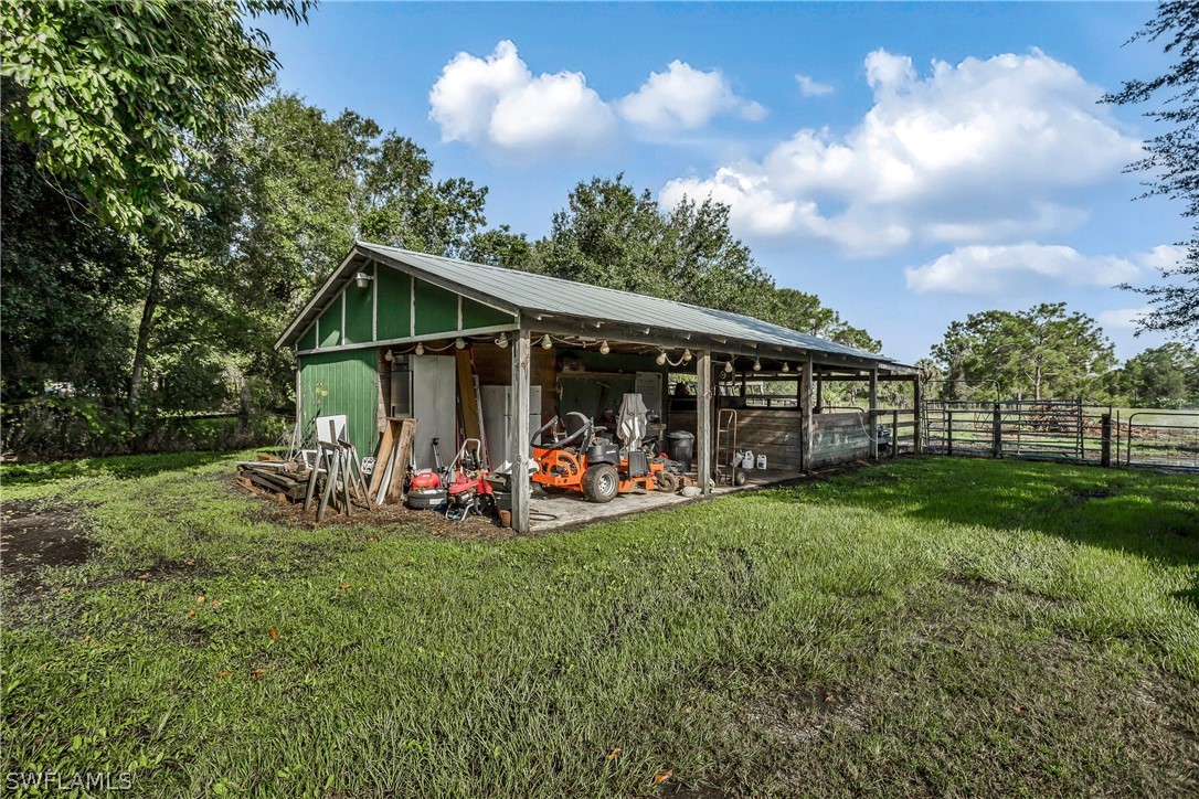 23751 North River Road Alva, FL 33920 - Photo 28 of 34 a view of a backyard with sitting area and slide
