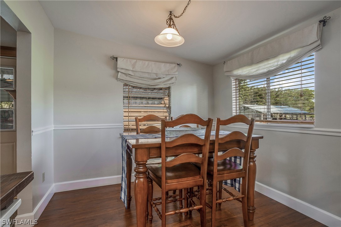 23751 North River Road Alva, FL 33920 - Photo 10 of 34 a view of a dining room with furniture window and wooden floor