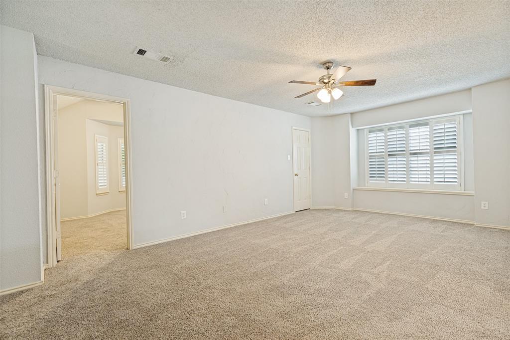 1215 Spring Creek Drive Allen, TX 75002 - Photo 21 of 40 Spacious room with plush carpeting and a neutral color palette