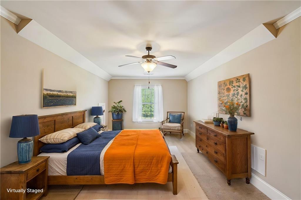 488 Townsend Street Grayson, GA 30017 - Photo 30 of 40 a spacious bedroom with a bed and wooden floor