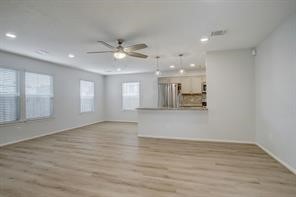 1304 Robin Street Houston, TX 77019 - Photo 11 of 11 Spacious living area, open floor plan, breakfast bar, new vinyl flooring & contemporary lighting.