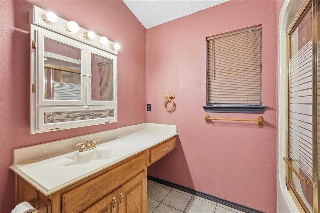 135 Private Road 2202 Decatur, TX 76234 - Photo 27 of 40 Bathroom with vanity, light tile patterned flooring, and lofted ceiling