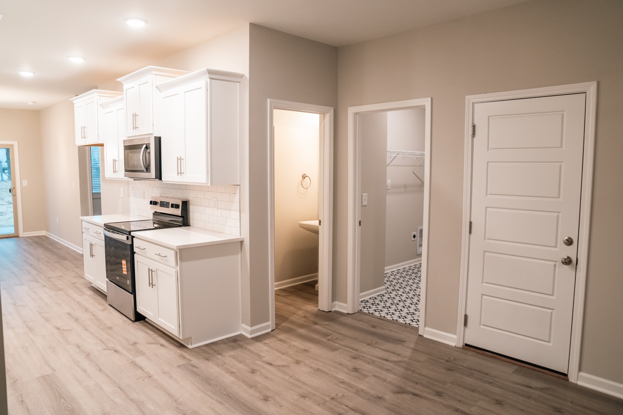 337 Carver Connection, Unit 33 Lebanon, TN 37087 - Photo 4 of 21 a kitchen with white cabinets and wooden floor