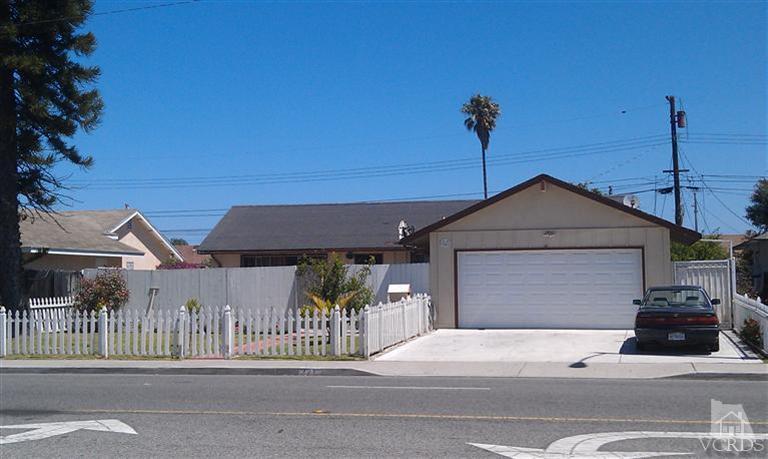 701 West Pleasant Valley Road Oxnard, CA 93033 - Photo 1 of 13 a front view of a house with a garage