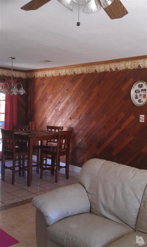 701 West Pleasant Valley Road Oxnard, CA 93033 - Photo 4 of 13 a living room with a couch and a dining table with rug