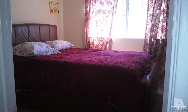 701 West Pleasant Valley Road Oxnard, CA 93033 - Photo 8 of 13 a bed sitting in a bedroom next to a window