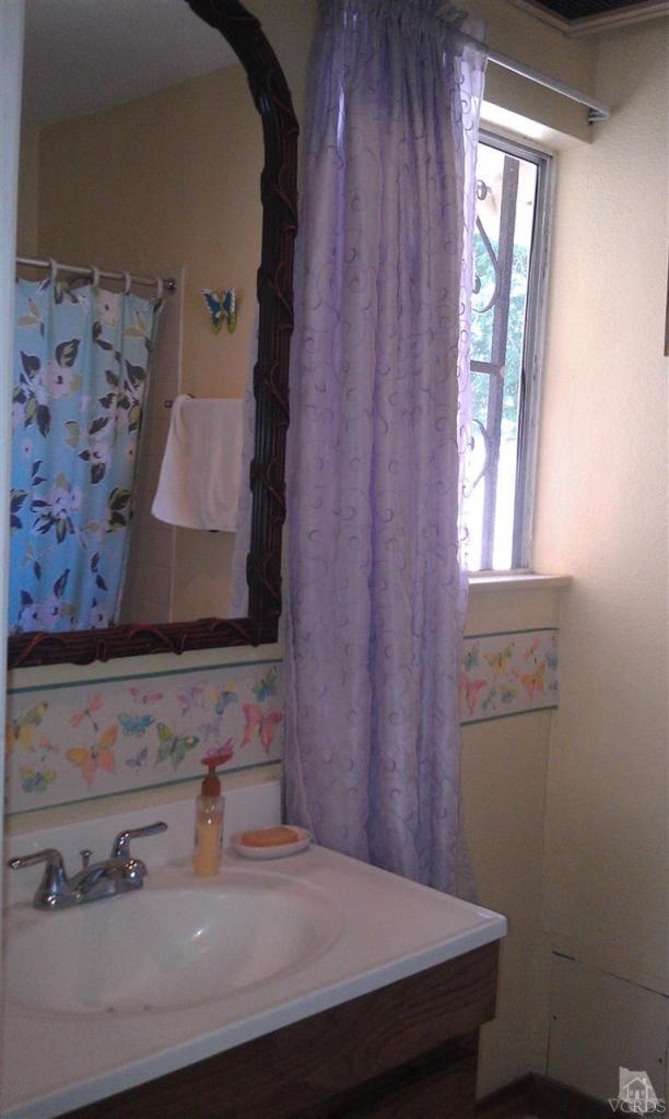 701 West Pleasant Valley Road Oxnard, CA 93033 - Photo 9 of 13 a bathroom with a sink and a mirror