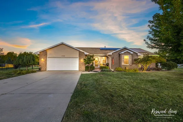 a front view of a house with a yard and garage