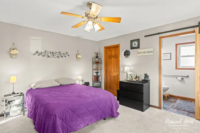 a spacious bedroom with a bed and a chandelier