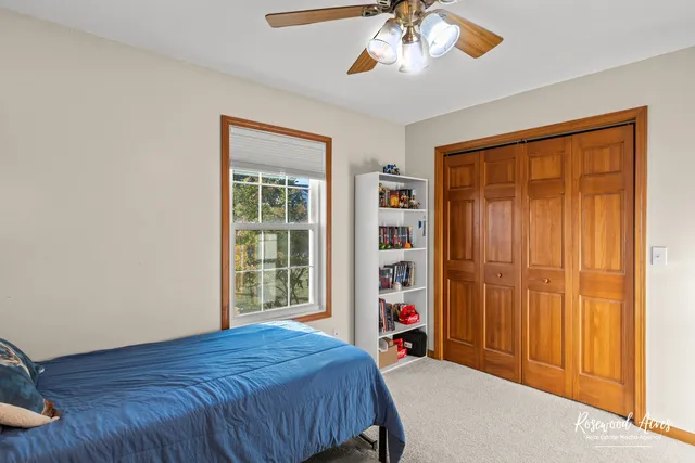 a bed sitting in a bedroom next to a window