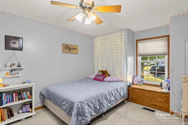 a bedroom with a bed and a book shelf
