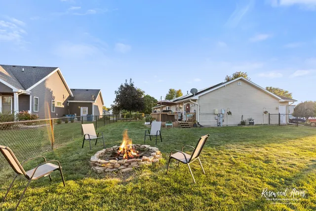 a view of a house with pool and a yard