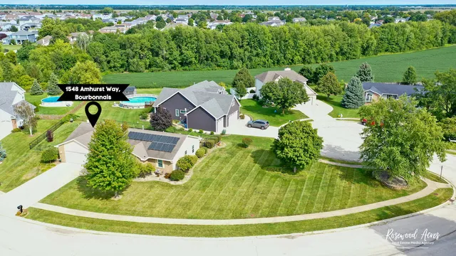 an aerial view of a house with a yard basket ball court and outdoor seating
