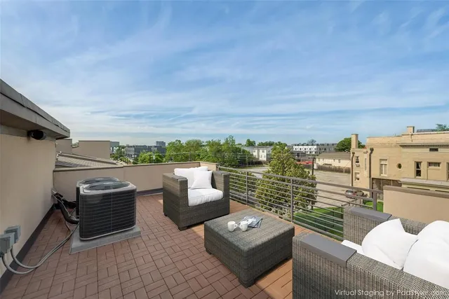 a view of roof deck with couches and potted plants