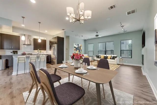 a view of a dining room with furniture a chandelier and wooden floor