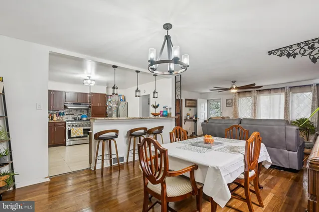 a view of a dining room with furniture wooden floor and chandelier