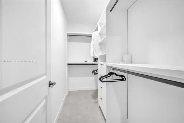 a bedroom with a bed and cabinet