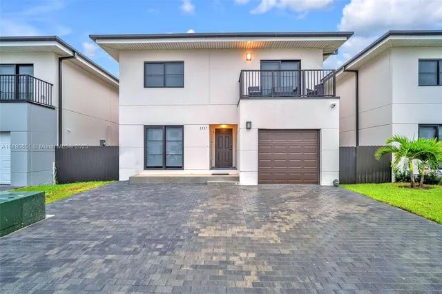 a view of a house with a yard and garage