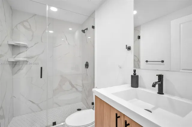 a kitchen with stainless steel appliances granite countertop a sink a stove and a wooden floors