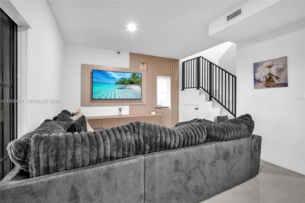 a living room with furniture and a flat screen tv
