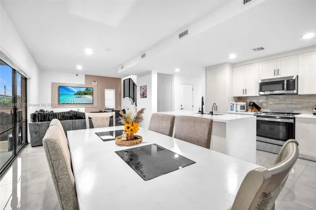 a kitchen with appliances a sink and cabinets