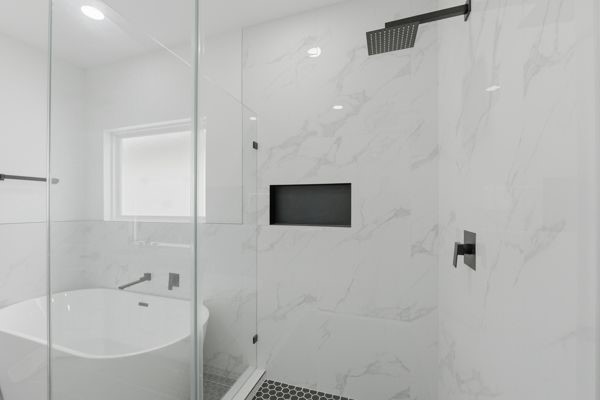6539 Sealey Street Houston, TX 77091 - Photo 21 of 28 a bathroom with a bathtub and a shower