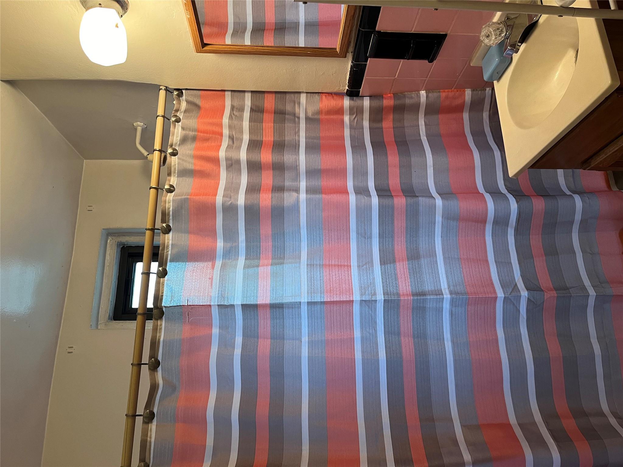 33-24 Junction Boulevard, Unit 3M Queens, NY 11372 - Photo 15 of 15 a bathroom with a sink and a mirror